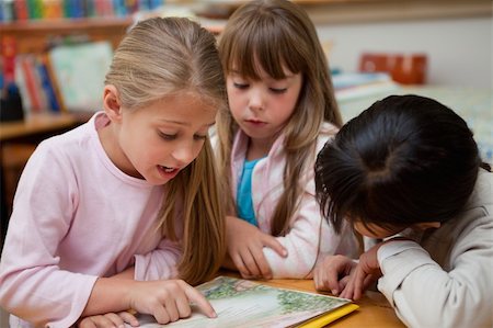 simsearch:400-05896357,k - Schoolgirls reading a fairy tale together in a classroom Stock Photo - Budget Royalty-Free & Subscription, Code: 400-05895113