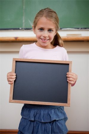 simsearch:400-05896424,k - Portrait of a young girl holding at a school slate in a classroom Stock Photo - Budget Royalty-Free & Subscription, Code: 400-05895120