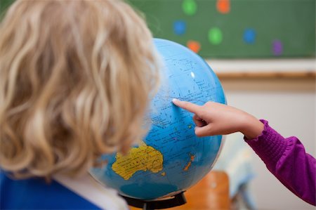 simsearch:630-03482408,k - Finger of a little girl showing a country to a classmate on a globe Stock Photo - Budget Royalty-Free & Subscription, Code: 400-05895132