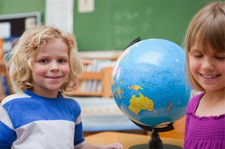 simsearch:630-03482408,k - Young pupils posing in front of a globe in a classroom Stock Photo - Budget Royalty-Free & Subscription, Code: 400-05895399