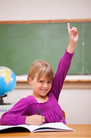 simsearch:400-05896357,k - Portrait of a schoolgirl raising her hand in a classroom Stock Photo - Budget Royalty-Free & Subscription, Code: 400-05895404