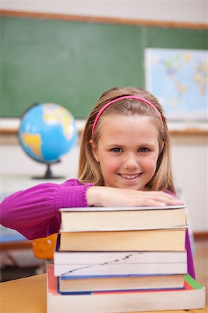 simsearch:400-05896424,k - Portrait of schoolgirl posing with books in a classroom Stock Photo - Budget Royalty-Free & Subscription, Code: 400-05895414