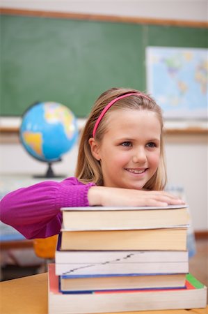 simsearch:400-05896424,k - Portrait of schoolgirl posing with a stack of books in a classroom Stock Photo - Budget Royalty-Free & Subscription, Code: 400-05895415