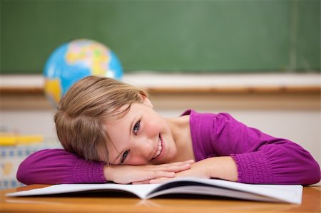 Schoolgirl leaning on her desk in a classroom Stock Photo - Budget Royalty-Free & Subscription, Code: 400-05895412