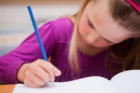 simsearch:400-05896357,k - Close up of a schoolgirl writing on a book Stock Photo - Budget Royalty-Free & Subscription, Code: 400-05895430