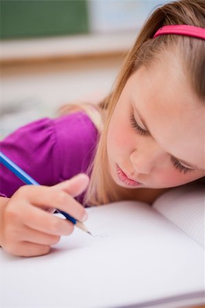 simsearch:400-05896357,k - Portrait of a young schoolgirl writing in a classroom Stock Photo - Budget Royalty-Free & Subscription, Code: 400-05895431
