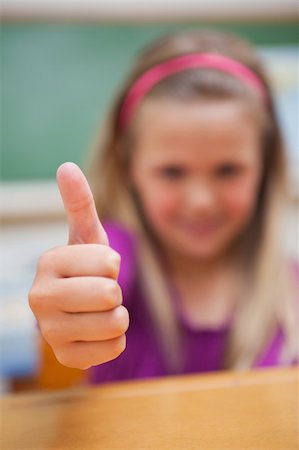 simsearch:400-05896424,k - Portrait of a cute schoolgirl with the thumb up with the camera focus on the thumb Stock Photo - Budget Royalty-Free & Subscription, Code: 400-05895486