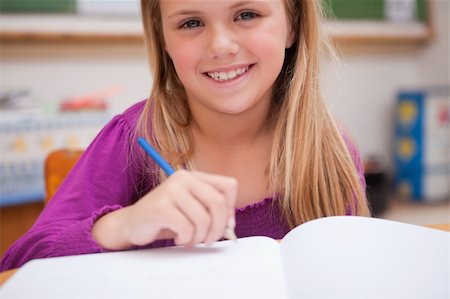 simsearch:400-05896357,k - Close up of a young schoolgirl writing in a classroom Stock Photo - Budget Royalty-Free & Subscription, Code: 400-05895481