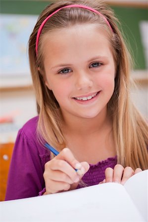 simsearch:400-05896357,k - Portrait of a little schoolgirl writing in a classroom Stock Photo - Budget Royalty-Free & Subscription, Code: 400-05895482