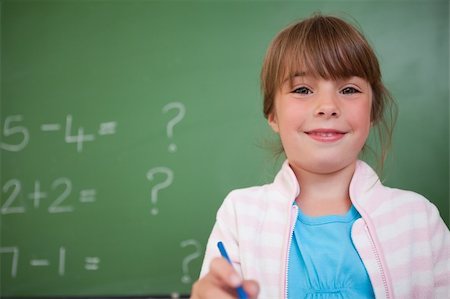 simsearch:400-05896357,k - Cute girl standing up in front of a blackboard Stock Photo - Budget Royalty-Free & Subscription, Code: 400-05895495