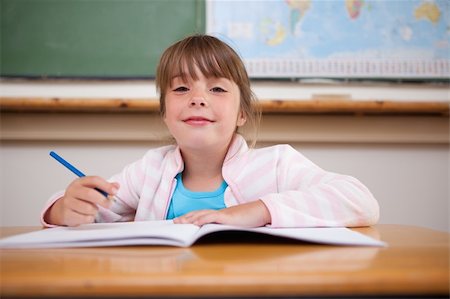 simsearch:400-05896357,k - Cute girl writing in a classroom Stock Photo - Budget Royalty-Free & Subscription, Code: 400-05895497