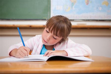 simsearch:400-05896357,k - Focused girl writing in a classroom Stock Photo - Budget Royalty-Free & Subscription, Code: 400-05895498