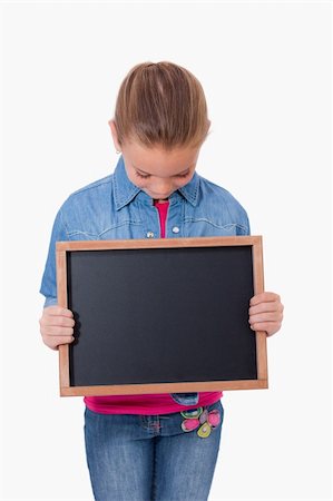 simsearch:400-05896424,k - Portrait of a young girl looking at a school slate against a white background Stock Photo - Budget Royalty-Free & Subscription, Code: 400-05895526
