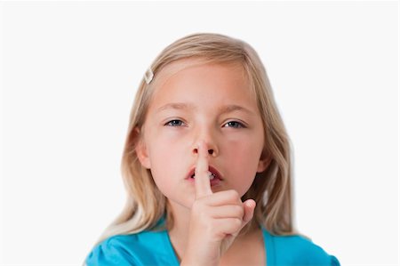 simsearch:400-04175955,k - Young girl asking for silence against a white background Stock Photo - Budget Royalty-Free & Subscription, Code: 400-05895569
