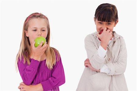 simsearch:400-05357982,k - Girls eating apples against a white background Stock Photo - Budget Royalty-Free & Subscription, Code: 400-05895659
