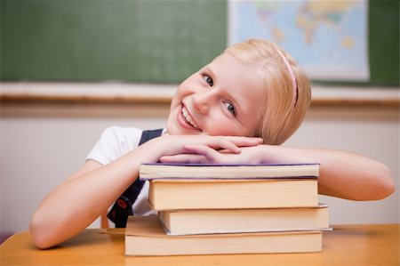 simsearch:400-05896424,k - Smiling girl leaning on books in a classroom Stock Photo - Budget Royalty-Free & Subscription, Code: 400-05896337
