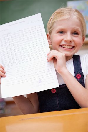 simsearch:400-05896357,k - Portrait of a girl showing her school report in a classroom Stock Photo - Budget Royalty-Free & Subscription, Code: 400-05896350