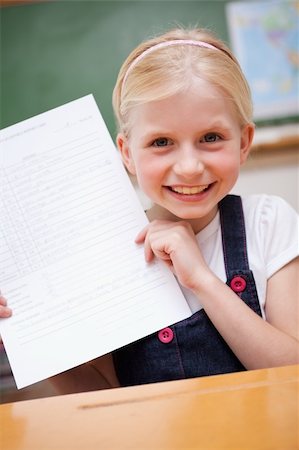 simsearch:400-05896357,k - Portrait of a happy girl showing her school report in a classroom Stock Photo - Budget Royalty-Free & Subscription, Code: 400-05896351