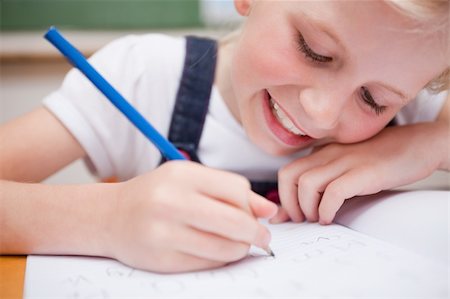 simsearch:400-05896357,k - Close up of a schoolgirl writing something in a classroom Stock Photo - Budget Royalty-Free & Subscription, Code: 400-05896353