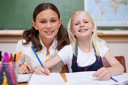 simsearch:400-05896357,k - Smiling pupils working together on an assignment in a classroom Stock Photo - Budget Royalty-Free & Subscription, Code: 400-05896368