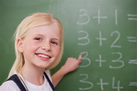 simsearch:625-01250891,k - Blonde schoolgirl pointing at something on a blackboard Stock Photo - Budget Royalty-Free & Subscription, Code: 400-05896378