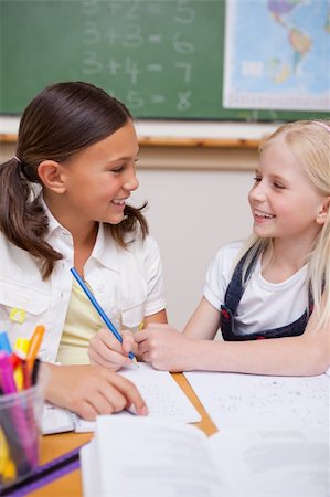 simsearch:400-05896357,k - Portrait of happy pupils working together on an assignment in a classroom Stock Photo - Budget Royalty-Free & Subscription, Code: 400-05896370