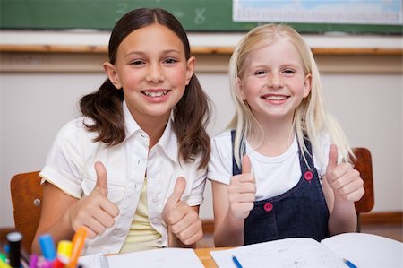 simsearch:400-05357982,k - Portrait of happy pupils working together with the thumbs up in a classroom Stock Photo - Budget Royalty-Free & Subscription, Code: 400-05896371