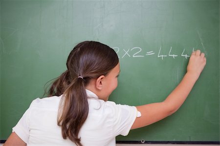 simsearch:400-05896357,k - Schoolgirl writing numbers on a blackboard Stock Photo - Budget Royalty-Free & Subscription, Code: 400-05896388