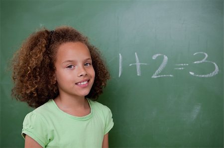 simsearch:625-01250891,k - Cute schoolgirl posing in front of an addition in a classroom Stock Photo - Budget Royalty-Free & Subscription, Code: 400-05896397