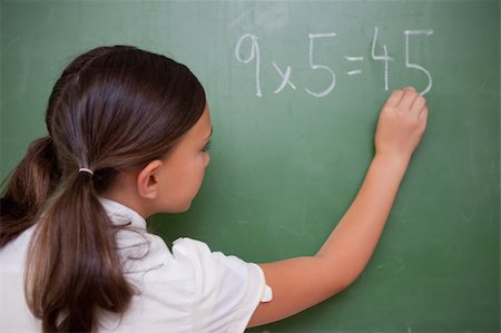 simsearch:400-05896357,k - Schoolgirl writing a result on a blackboard Stock Photo - Budget Royalty-Free & Subscription, Code: 400-05896390