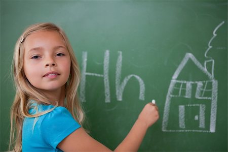 simsearch:400-07042264,k - Schoolgirl learning the alphabet on a blackboard Stock Photo - Budget Royalty-Free & Subscription, Code: 400-05896506