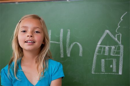 simsearch:400-07042264,k - Blonde schoolgirl posing in front of a blackboard in a classroom Stock Photo - Budget Royalty-Free & Subscription, Code: 400-05896507