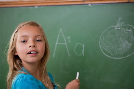 simsearch:400-08315791,k - Young schoolgirl learning the alphabet on a blackboard Foto de stock - Super Valor sin royalties y Suscripción, Código: 400-05896508