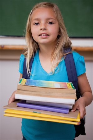 simsearch:400-05896424,k - Portrait of a happy schoolgirl holding her books in a classroom Stock Photo - Budget Royalty-Free & Subscription, Code: 400-05896513