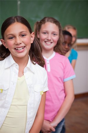 simsearch:400-05896424,k - Portrait of classmates posing in a row in a classroom Stock Photo - Budget Royalty-Free & Subscription, Code: 400-05896560