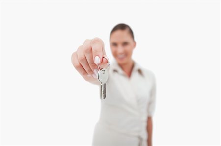 simsearch:400-04663994,k - Female real estate agent holding keys with the camera focus on the object Stock Photo - Budget Royalty-Free & Subscription, Code: 400-05898241