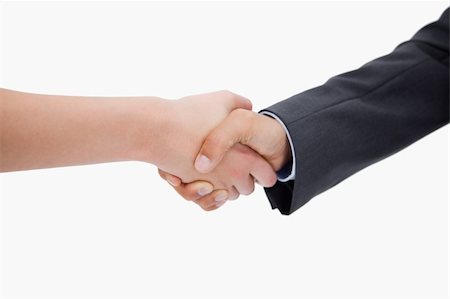 simsearch:400-04333648,k - Close up of a handshake against a white background Stock Photo - Budget Royalty-Free & Subscription, Code: 400-05898267