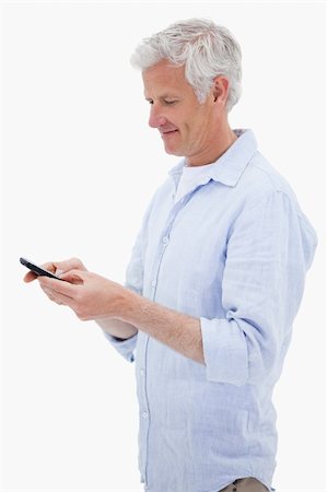 simsearch:400-06632132,k - Portrait of a man using his mobile phone against a white background Stock Photo - Budget Royalty-Free & Subscription, Code: 400-05898528