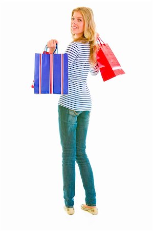 simsearch:400-05888428,k - Smiling teen girl with shopping bags looking back Stock Photo - Budget Royalty-Free & Subscription, Code: 400-05890657