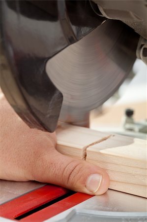 dangerous accident - Labor safety concept - man about to cut finger with power tool Stock Photo - Budget Royalty-Free & Subscription, Code: 400-05890749