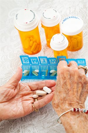 Closeup of an elderly woman's hands sorting her medication for the week. Stock Photo - Budget Royalty-Free & Subscription, Code: 400-05890998