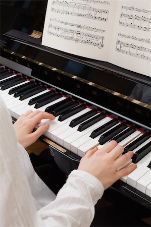 pianist (female) - Photo of a young girl playing the piano with sheet music open. Stock Photo - Budget Royalty-Free & Subscription, Code: 400-05892042