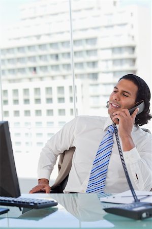 simsearch:859-06710917,k - Portrait of a businessman on the phone while looking at his computer in his office Stock Photo - Budget Royalty-Free & Subscription, Code: 400-05892348