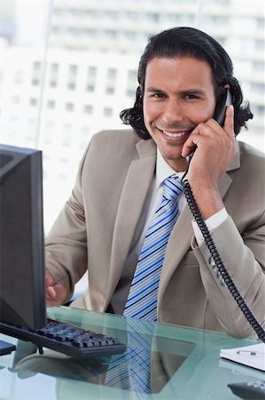 simsearch:859-06710917,k - Portrait of a businessman working with a monitor while being on the telephone in his office Stock Photo - Budget Royalty-Free & Subscription, Code: 400-05892343