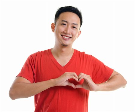 Asian young forming a heart shape on white background Foto de stock - Super Valor sin royalties y Suscripción, Código: 400-05905700
