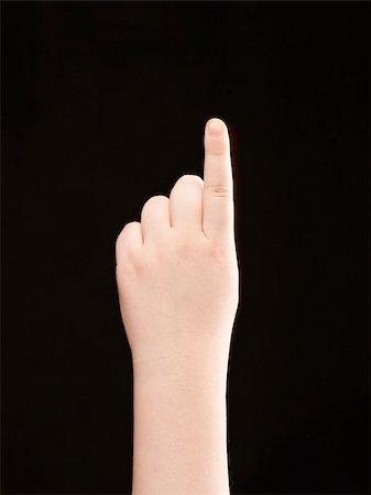 simsearch:400-04586134,k - Childs hand with index finger pointing - black background Stock Photo - Budget Royalty-Free & Subscription, Code: 400-05906365