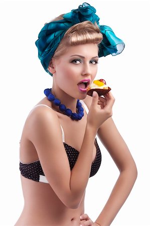 young sexy blond girl with blue head scarf and bra in pin up style eating a big pastry with open mouth Stock Photo - Budget Royalty-Free & Subscription, Code: 400-05909915