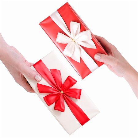 female hand holding red and white gift boxes with a bow isolated on white background Stock Photo - Budget Royalty-Free & Subscription, Code: 400-05909948