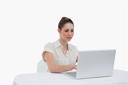 simsearch:400-05729275,k - Businesswoman using a laptop against a white background Stock Photo - Budget Royalty-Free & Subscription, Code: 400-05900557