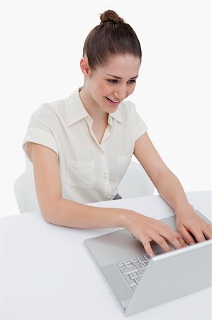 simsearch:400-05729275,k - Portrait of a businesswoman using a notebook against a white background Stock Photo - Budget Royalty-Free & Subscription, Code: 400-05900560